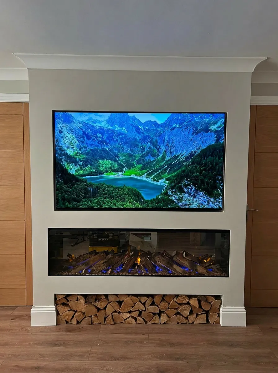 Bespoke media wall by TVI UK — flush-mounted TV with built-in fireplace and log store